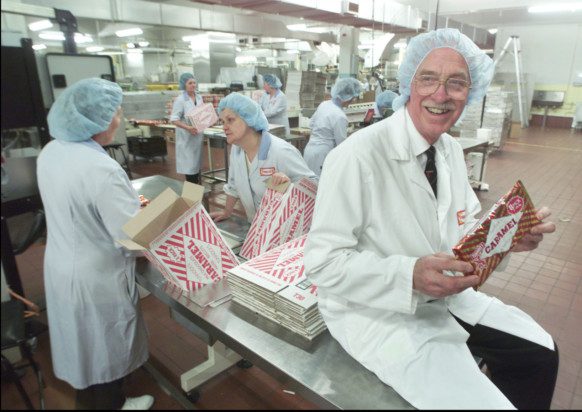 Boyd Tunnock with staff on the caramel wafers production line. Picture: TSPL
