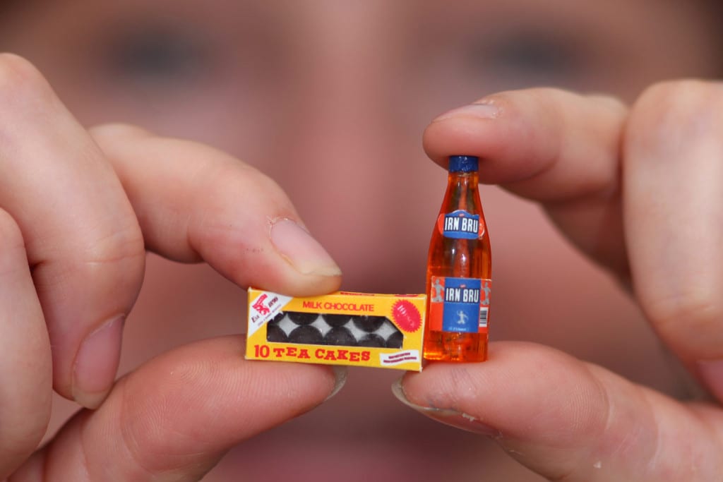 Dolls house maker Sheena Hinks holds her miniature Tea cakes and Irn Bru creations. Picture: TSPL