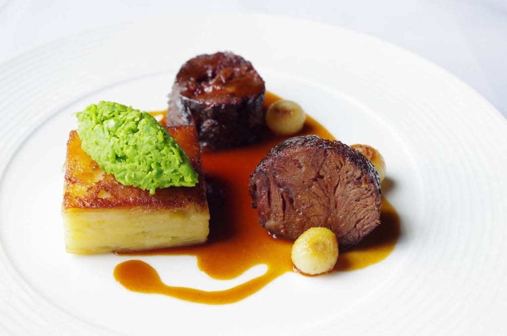 Slow cooked ox cheek, potato terrine, baby onions, and crushed peas. Picture: UC