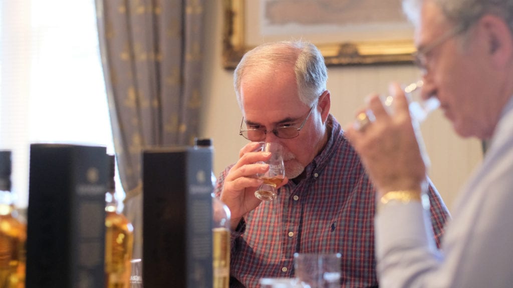 Eddie listens in as Dennis talks about his whisky. Picture: Alex Mitchell