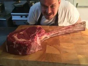 Head chef John Molloy with one of the famed Tomahawk steaks