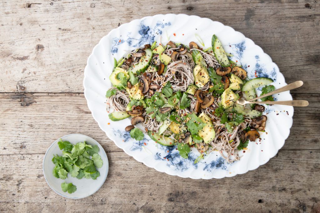 Soba noodle salad tossed with sesame spicy fried mushrooms with quickly pickled cucumbers, spring onions and coriander