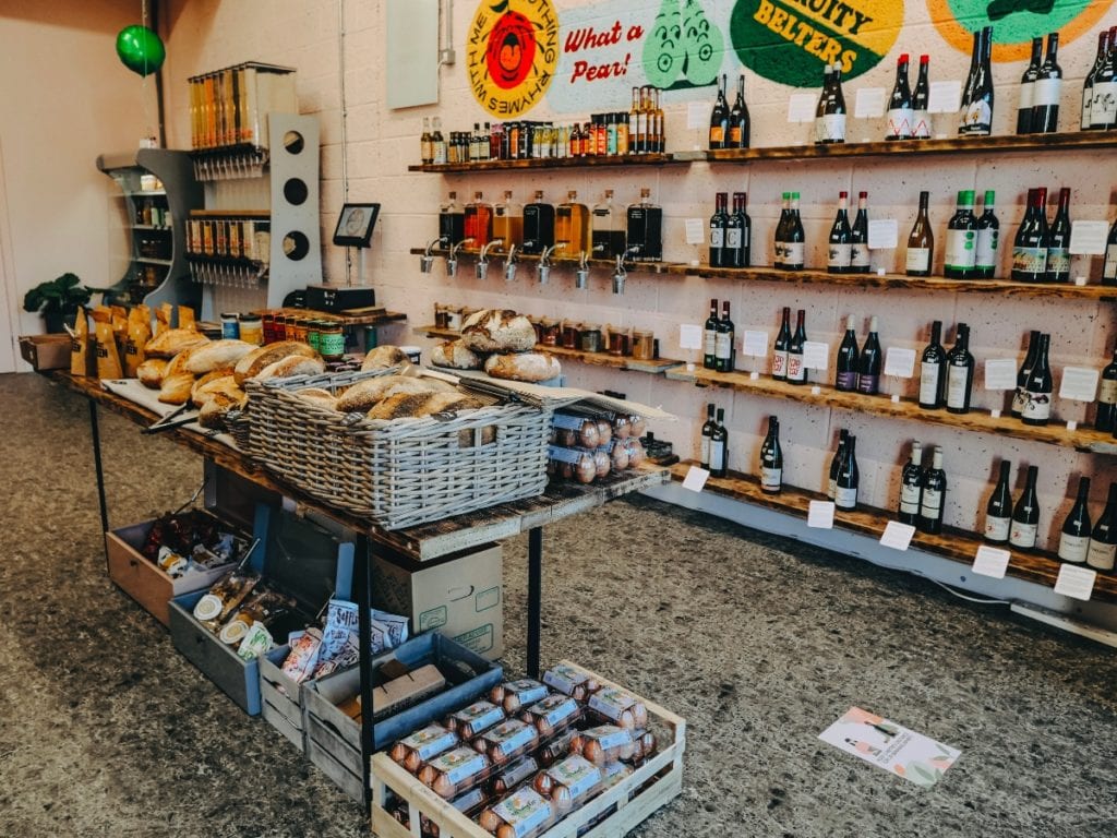 Image of shop floor with wine selection and bakery