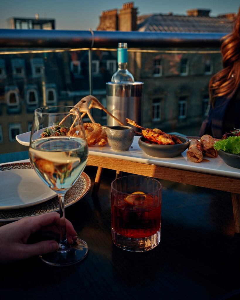 One of Chaophraya Edinburgh's Thai dishes, with drinks and a view from its balcony. 
