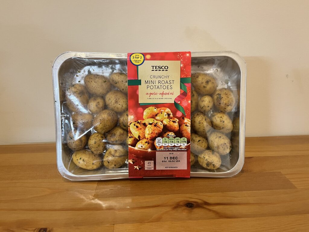 Tesco Crunchy Mini Roast Potatoes  leaning against a wall